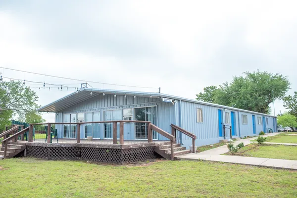 Park building with a covered deck and string lights