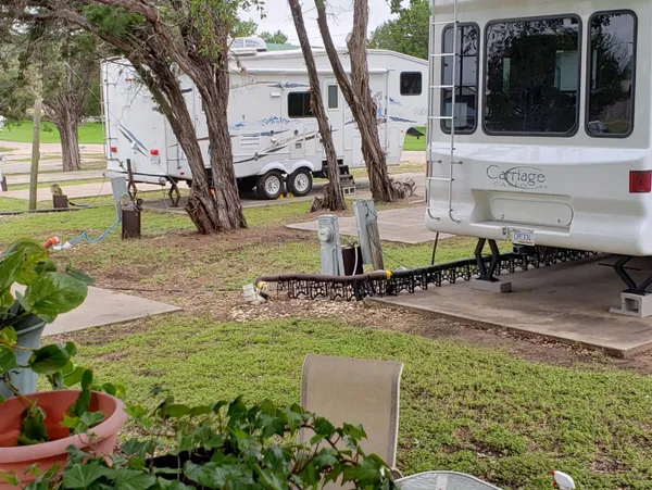 Fifth-wheel RV at a grassy site