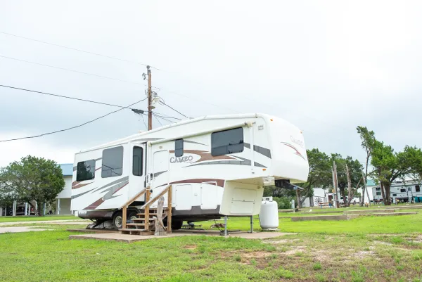 Fifth-wheel RV on open grass